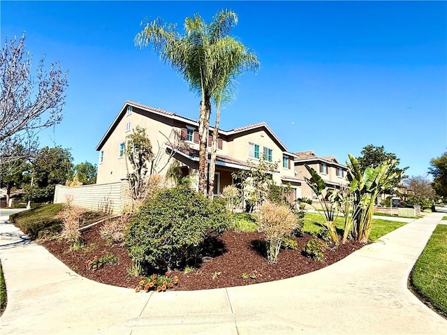 view of property exterior featuring a tile roof and stucco siding