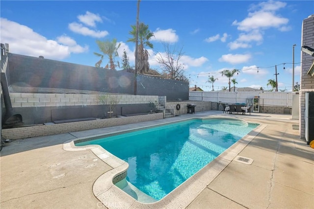 view of swimming pool featuring a patio