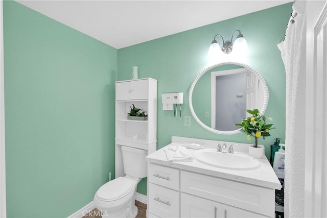 bathroom featuring vanity and toilet