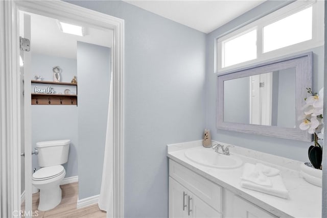 bathroom featuring hardwood / wood-style flooring, vanity, and toilet