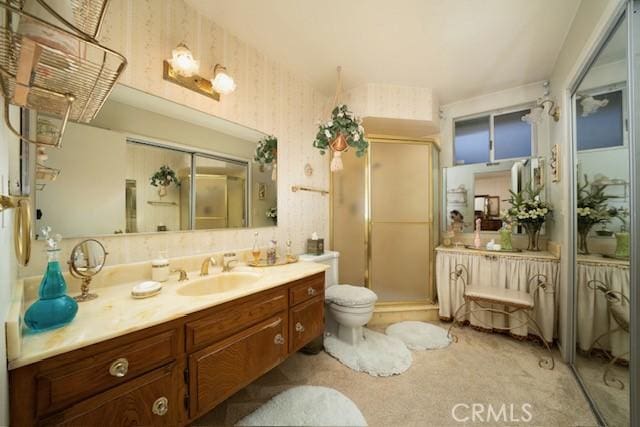 bathroom featuring a stall shower, vanity, and wallpapered walls