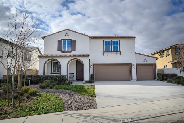 mediterranean / spanish-style house featuring a garage