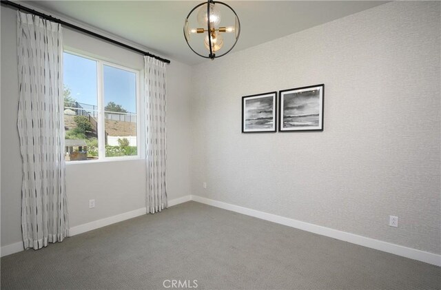 26235 Cherry Plum Cir, Menifee, CA 92584 - carpeted empty room with baseboards and a notable chandelier