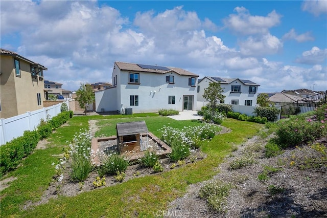 26235 Cherry Plum Cir, Menifee, CA 92584 - back of property with a fenced backyard, a patio area, a yard, a residential view, and solar panels