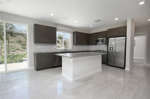 26235 Cherry Plum Cir, Menifee, CA 92584 - kitchen featuring plenty of natural light, a sink, tasteful backsplash, and stainless steel appliances