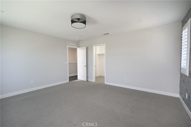 26235 Cherry Plum Cir, Menifee, CA 92584 - unfurnished bedroom with visible vents, carpet, baseboards, and a spacious closet