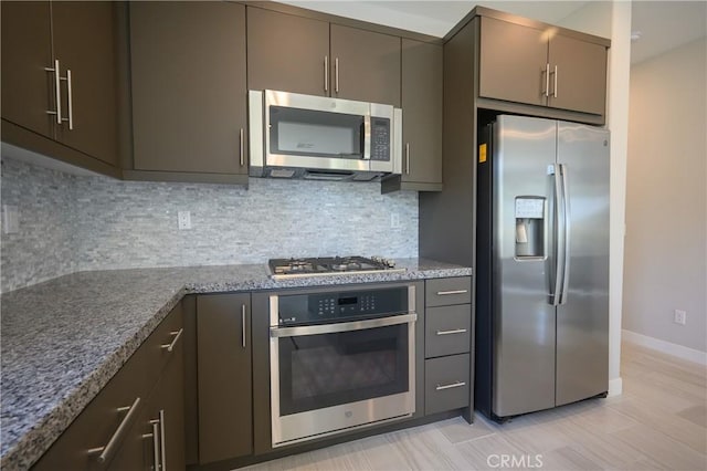 26235 Cherry Plum Cir, Menifee, CA 92584 - kitchen featuring baseboards, backsplash, stainless steel appliances, and light stone countertops