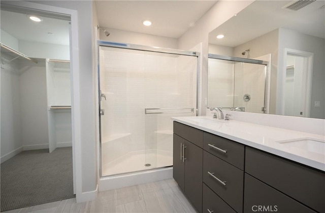 26235 Cherry Plum Cir, Menifee, CA 92584 - full bath featuring visible vents, a sink, a walk in closet, and a stall shower