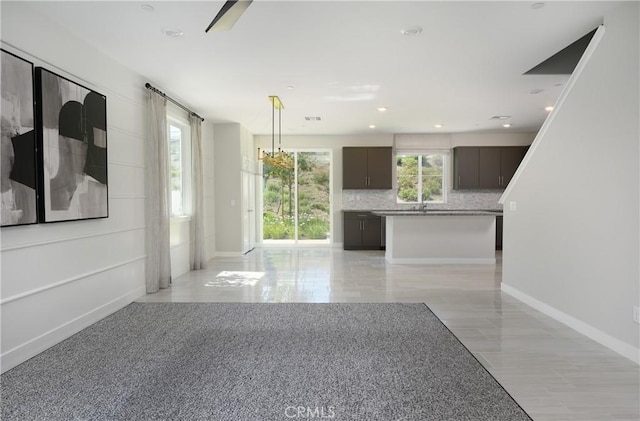 26235 Cherry Plum Cir, Menifee, CA 92584 - unfurnished living room with baseboards and recessed lighting