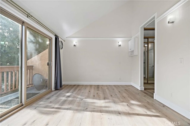 empty room featuring lofted ceiling and light wood-type flooring