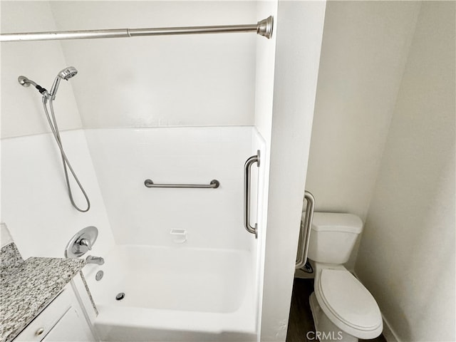 bathroom featuring toilet and bathing tub / shower combination