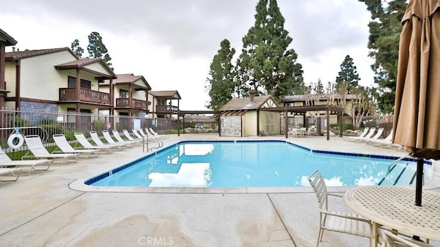 view of swimming pool featuring a pergola and a patio