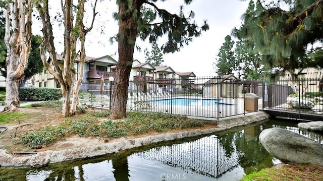 view of swimming pool featuring a water view