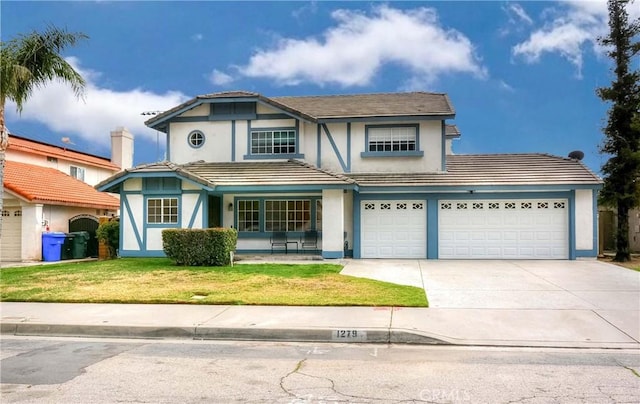 view of front of house with a garage and a front yard