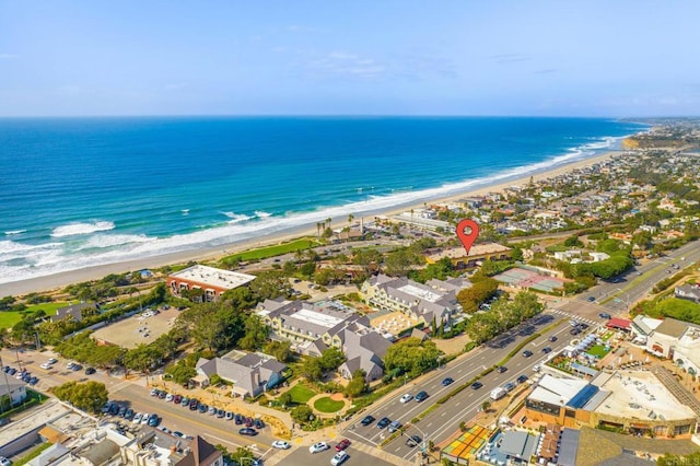birds eye view of property featuring a beach view and a water view