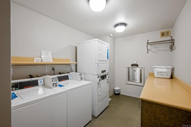 community laundry room featuring separate washer and dryer, baseboards, visible vents, and stacked washer / dryer