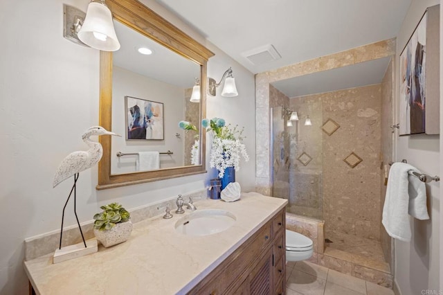 bathroom with tile patterned floors, vanity, toilet, visible vents, and tiled shower