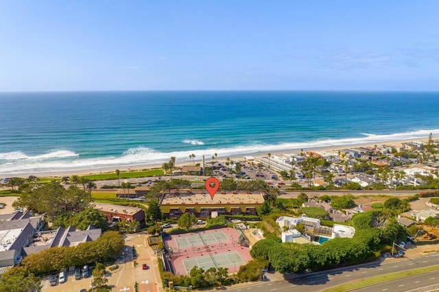 birds eye view of property with a beach view and a water view