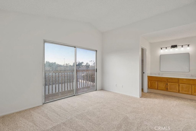 unfurnished bedroom with light carpet, access to outside, and a textured ceiling