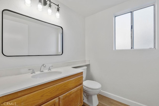 bathroom with vanity, hardwood / wood-style floors, and toilet