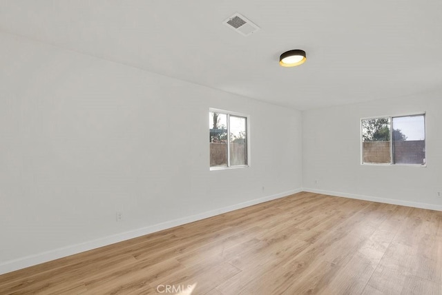 empty room with light hardwood / wood-style floors