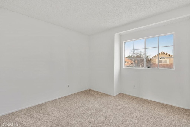 unfurnished room featuring carpet floors and a textured ceiling