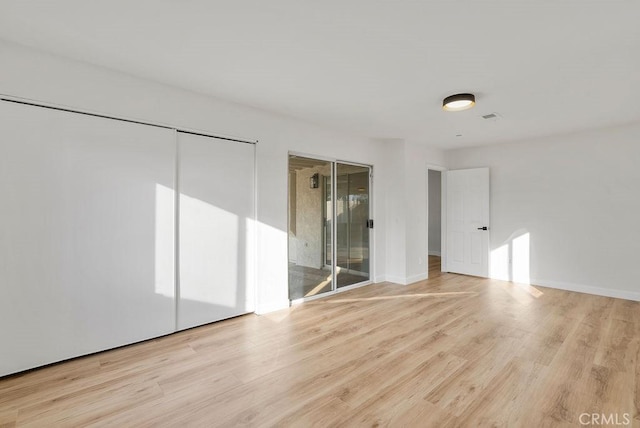 unfurnished room with light wood-type flooring