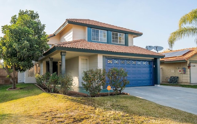 mediterranean / spanish home with a garage and a front lawn