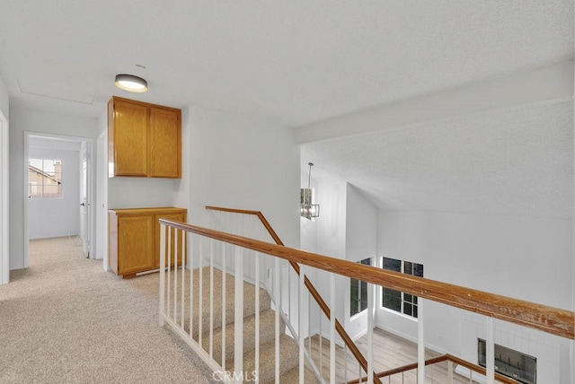 hallway with light colored carpet