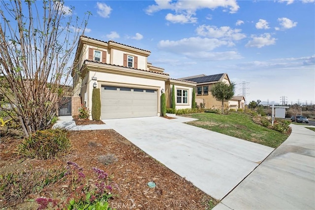 view of front facade with stucco siding, solar panels, concrete driveway, an attached garage, and a front yard