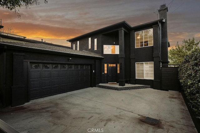 view of front of home with a patio area and a garage