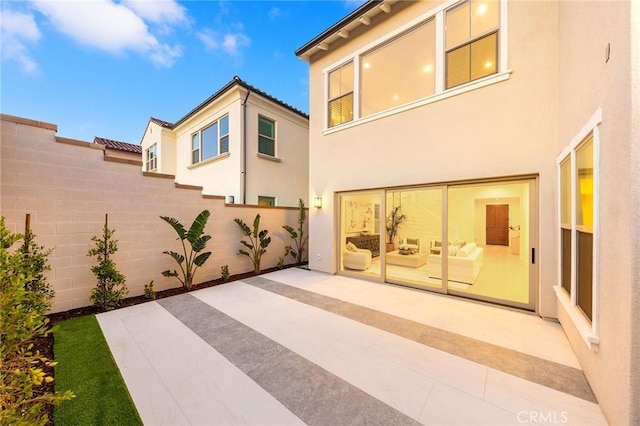 back of property with a patio