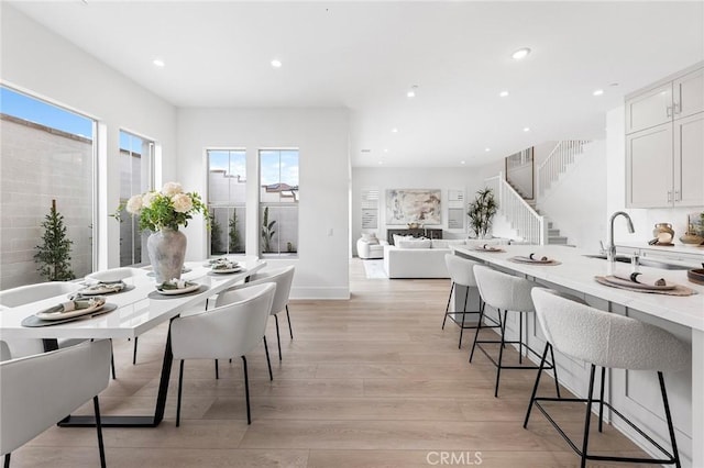 dining room featuring sink and light hardwood / wood-style floors