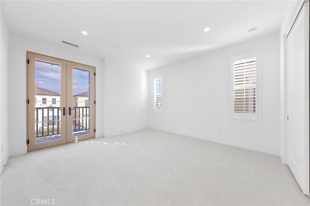 carpeted empty room with french doors