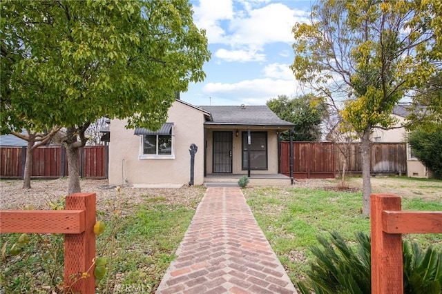 bungalow-style home featuring a front yard