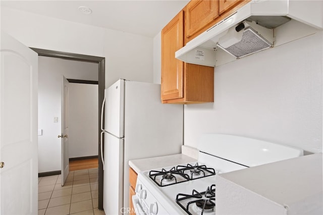 kitchen featuring light tile patterned floors and gas range gas stove