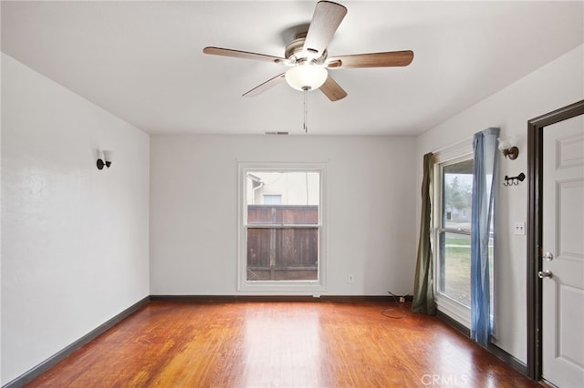 spare room featuring hardwood / wood-style floors and ceiling fan