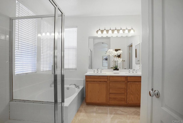 bathroom featuring vanity and independent shower and bath