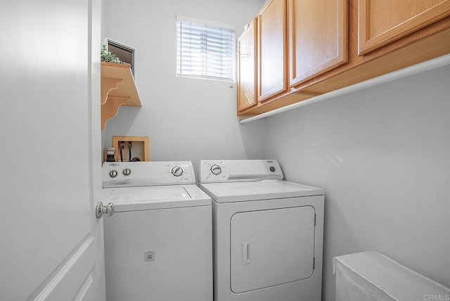 laundry room featuring cabinets and washing machine and dryer