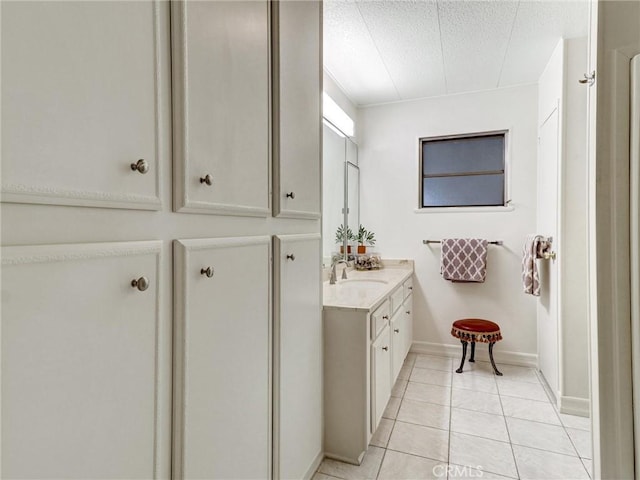 bathroom with vanity, tile patterned flooring, and a textured ceiling