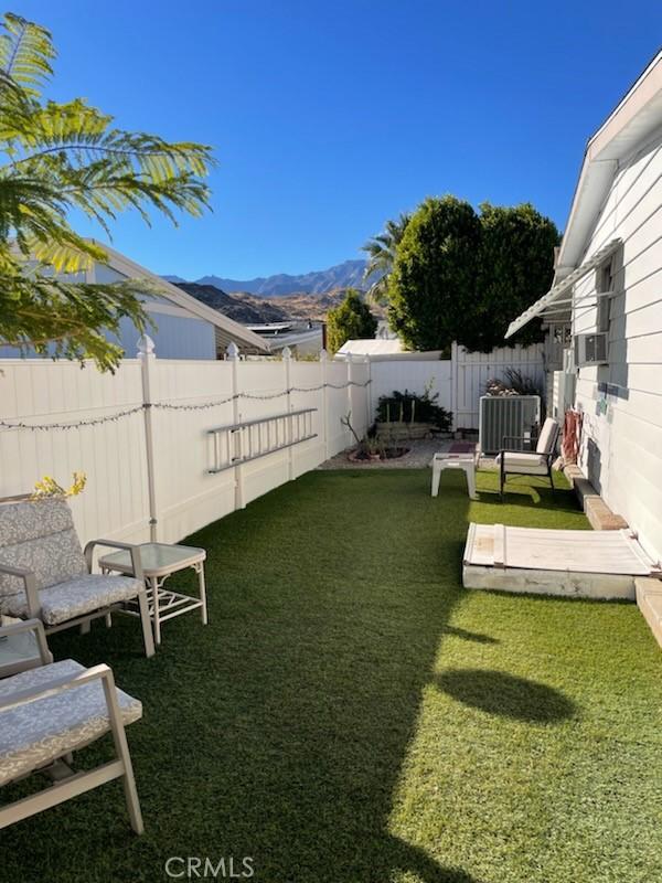 view of yard with a mountain view and cooling unit