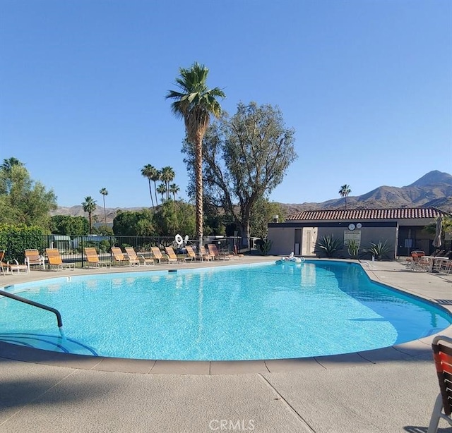 pool with fence and a patio