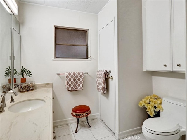 bathroom featuring vanity, tile patterned floors, and toilet