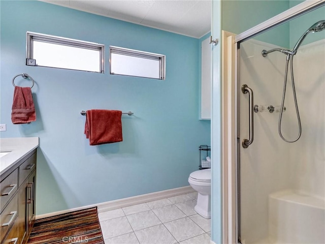 bathroom with tile patterned flooring, toilet, vanity, baseboards, and a stall shower