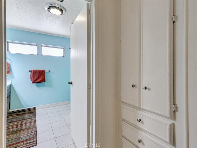 bathroom with tile patterned floors and a textured ceiling