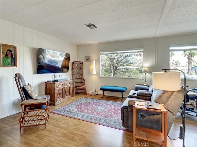 living room featuring a wealth of natural light and light hardwood / wood-style floors