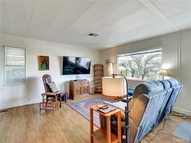 living room featuring visible vents and wood finished floors