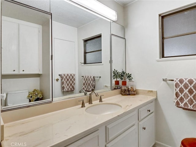 bathroom featuring toilet and vanity