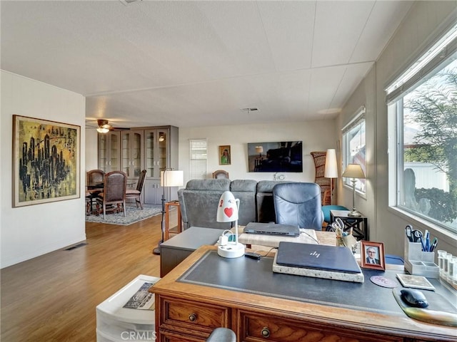 office with ceiling fan, wood finished floors, and visible vents