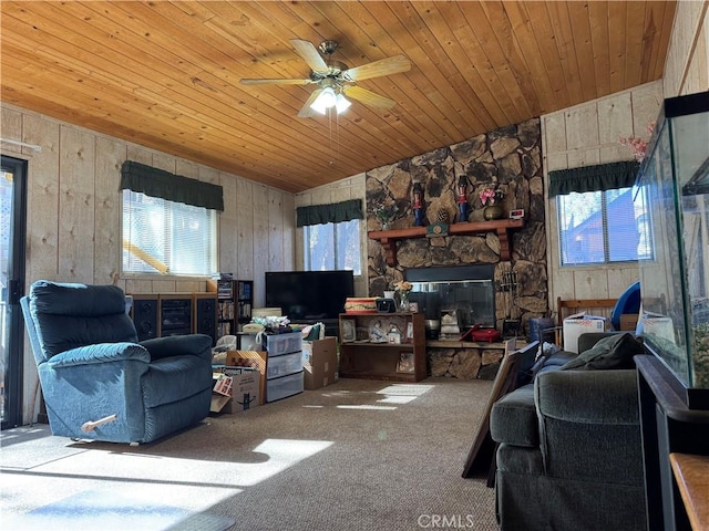 living area featuring plenty of natural light, wooden ceiling, a fireplace, and carpet